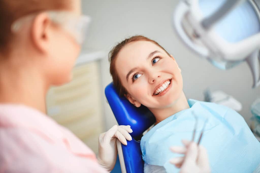 dental patient smiling in chair Home Dr. Darren Dotson D.D.S. Dr. Amy Hartzell D.D.S. Hill Avenue Dental. General, Cosmetic, Restorative, Preventative, Family Dentistry Dentist in Spirit Lake, IA 51360