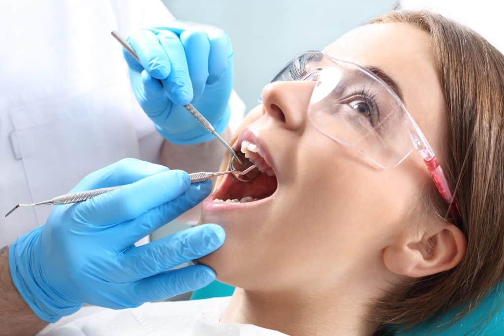 dental hygienist cleaning teeth