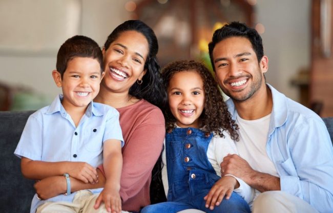 Love,,Portrait,And,Parents,With,Children,On,Sofa,For,Relax, restorative dentist spirit lake