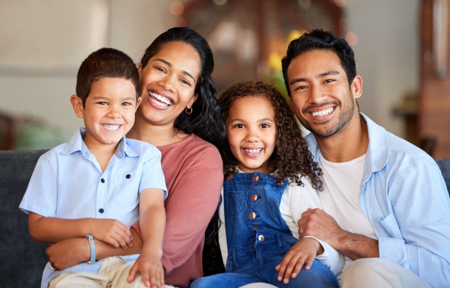 Love,,Portrait,And,Parents,With,Children,On,Sofa,For,Relax, restorative dentist spirit lake