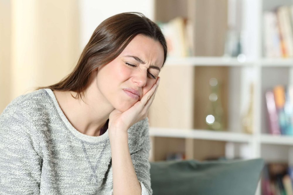 Stressed,Woman,Suffering,Toothache,Complaining,Touching,Cheek,On,A,Couch emergency dentist spirit lake